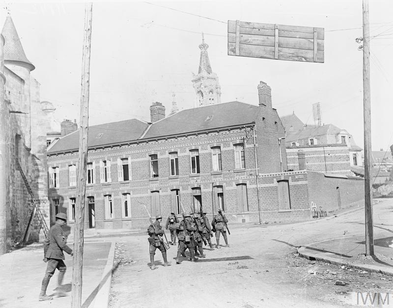 British infantry advancing through the streets of Cambrai circa October 1918.