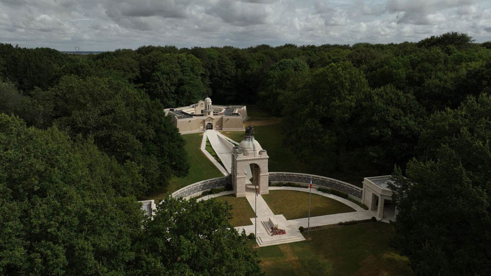 Delville Wood Memorial and Visitor Centre nestled in a clearing amidt thick woodland.