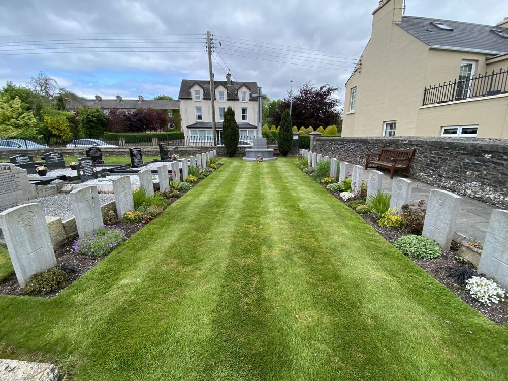 Two rows of CWGC headstones facing each other at Irvinestone Church of Ireland Churchyard.