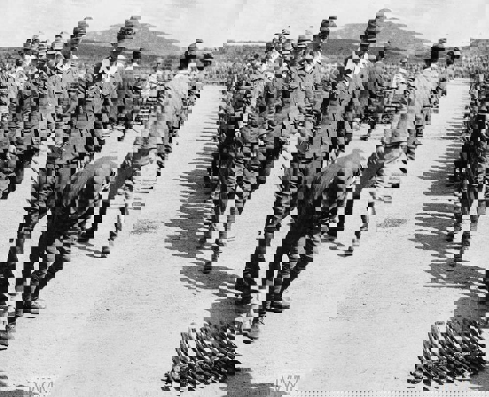 Japanese officers lay their swords on the ground in an act of surrender to British authorities in Malaysia, circa August 1945.