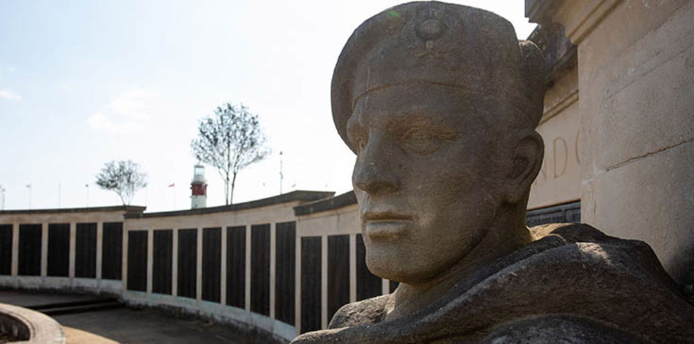 Close up of a weather-worn statue's face of a British sailor from ww2 at Portsmouth Naval Memorial