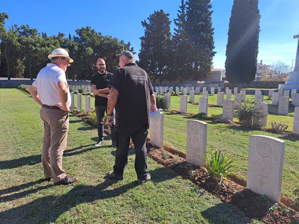 CWGC gardeners discuss graves within the bounds of a Greek Commonwealth War Graves Cemetery