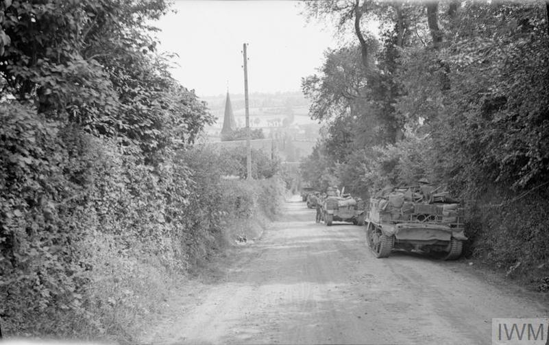 A line of Universal Carriers forming up down a Normandy lane circa July 1944.