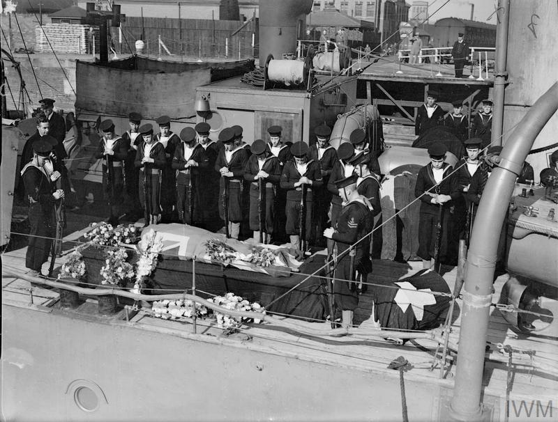 Scene on board the coastal minelayer HMS PLOVER as she departs for sea carrying the body of Captain J G Bickford DSO, who was killed on board HMS EXPRESS, in preparation for a traditional burial at sea.