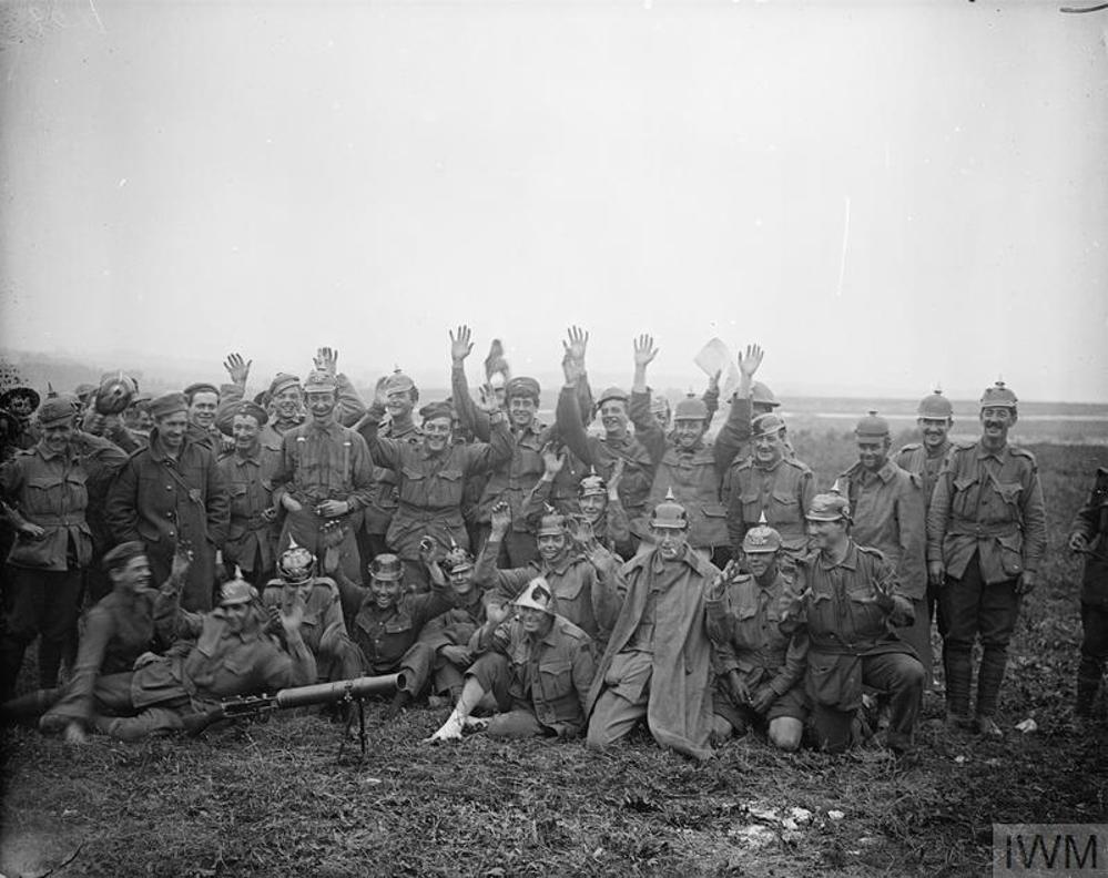 Australian Soldiers pose triumphantly, some wearing captured German picklehaube helmets, after the Battle of Pozieres
