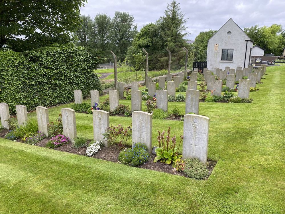 CWGC headstones arrayed in several rows in the CWGC plot at Irvinestown Church of Ireland Churchyard.