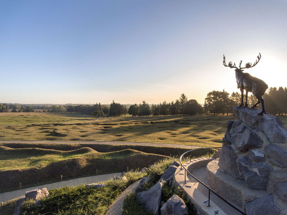 View of the preserved trenches and shell-pitted landscape of Newfoundland Memorial Park from the central bronze Caribou memoiral statue.