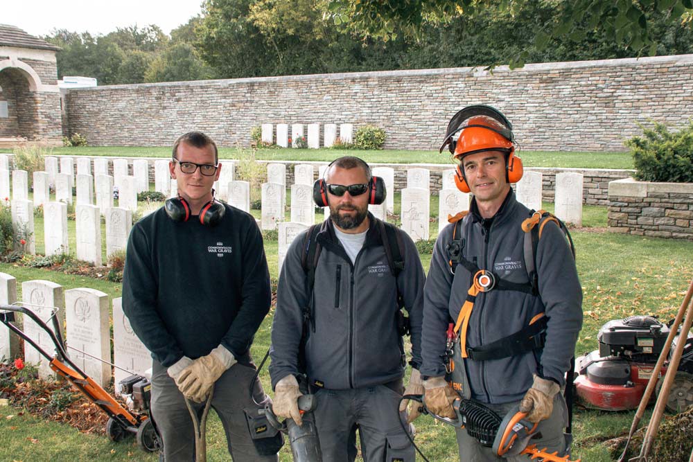 CWGF gardeners against the headstones at Loos British Cemetery.