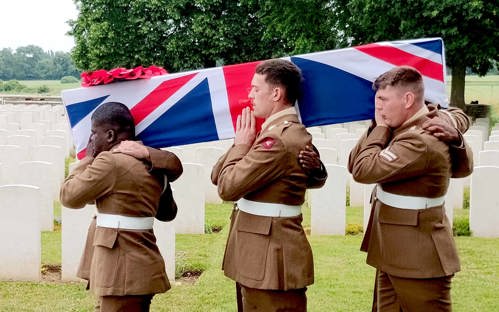 Serving soldiers of 14th Regiment Royal Artillery carrying the coffin to the graveside