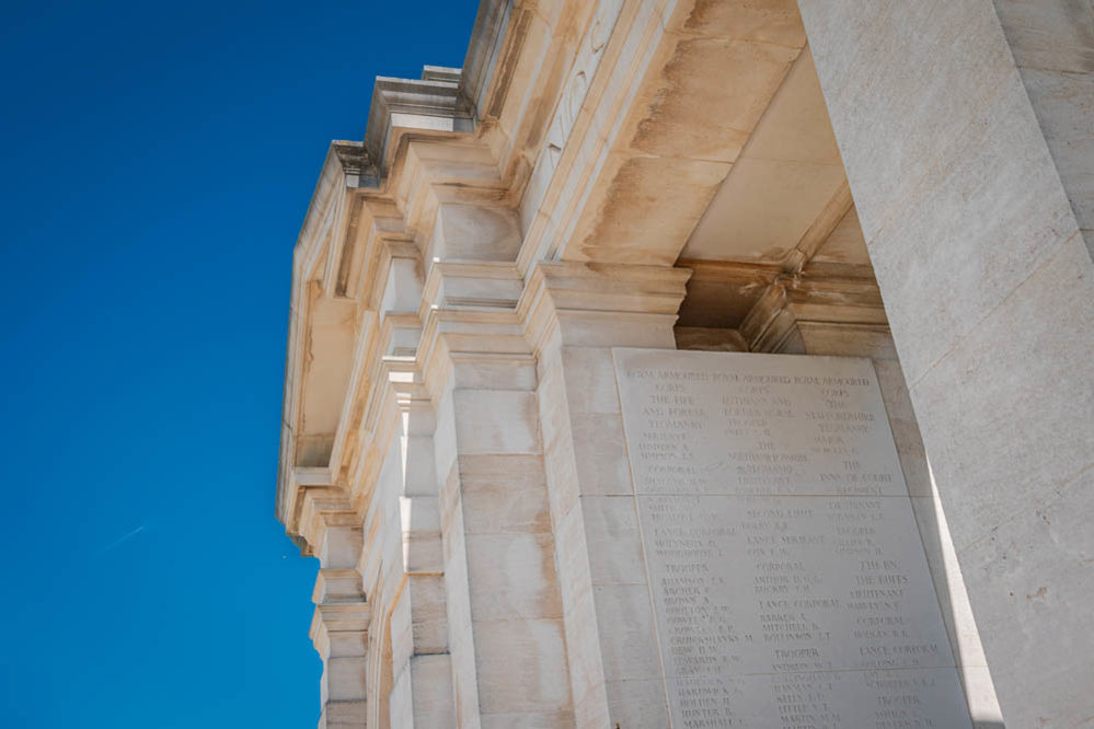 Bayeux Memorial close up of stone masonry and name panels, showing weathering and wear and tear after years of exposure to the Normandy weather.