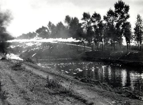 Crocodile flamethrower tank spurts napalm over the Leopold Canal.