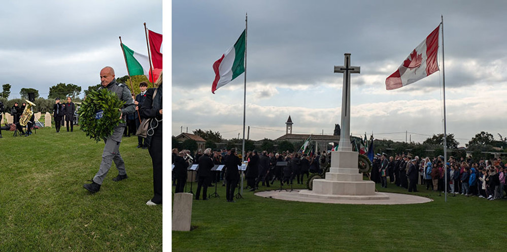 Man laying a wreath at CWGC remembrance service at Moro River Canadian War Cemetery. THe right of the image also shows ceremony attendees gathered around the cemetery Cross of Sacrifice, flanked by an Italian and a Canadian flag.