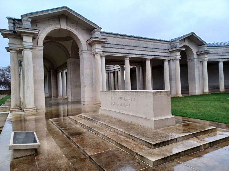 A rain-slicked Arras Memorial and Stone of Remembrance