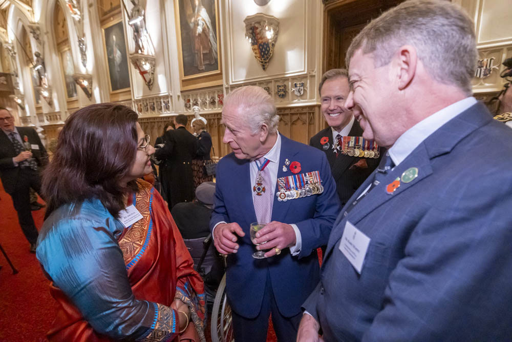 King Charles III in conversation with guests at an event.