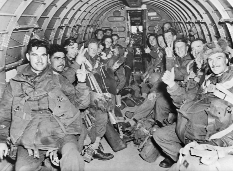 British paratroopers pose for the camera on their way to Arnhem in the hold of their transport plane.