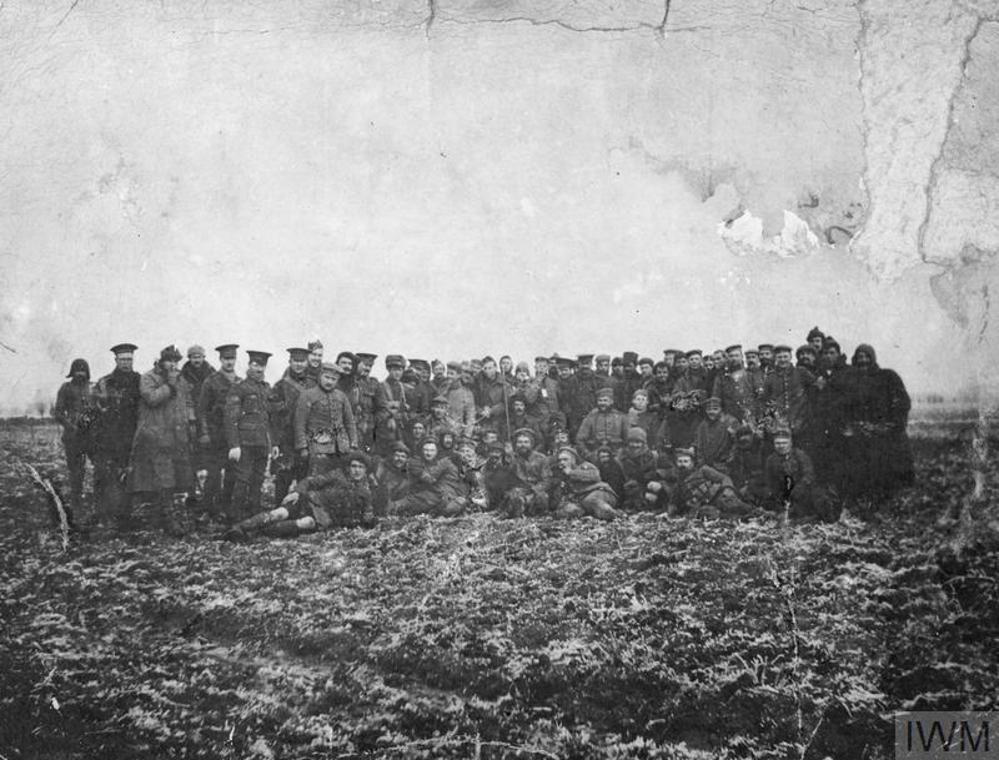 A slifghtly crumpled black and white photo of the men of the Coldstream Guards fraternising with German infantry during the 1914 Christmas truce.