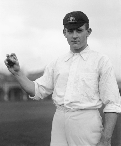 Albert Cotter in his cricket whites holding a cricket ball.