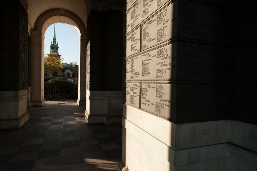 A church spire visible through an archway at the Tower Hill Memorial.